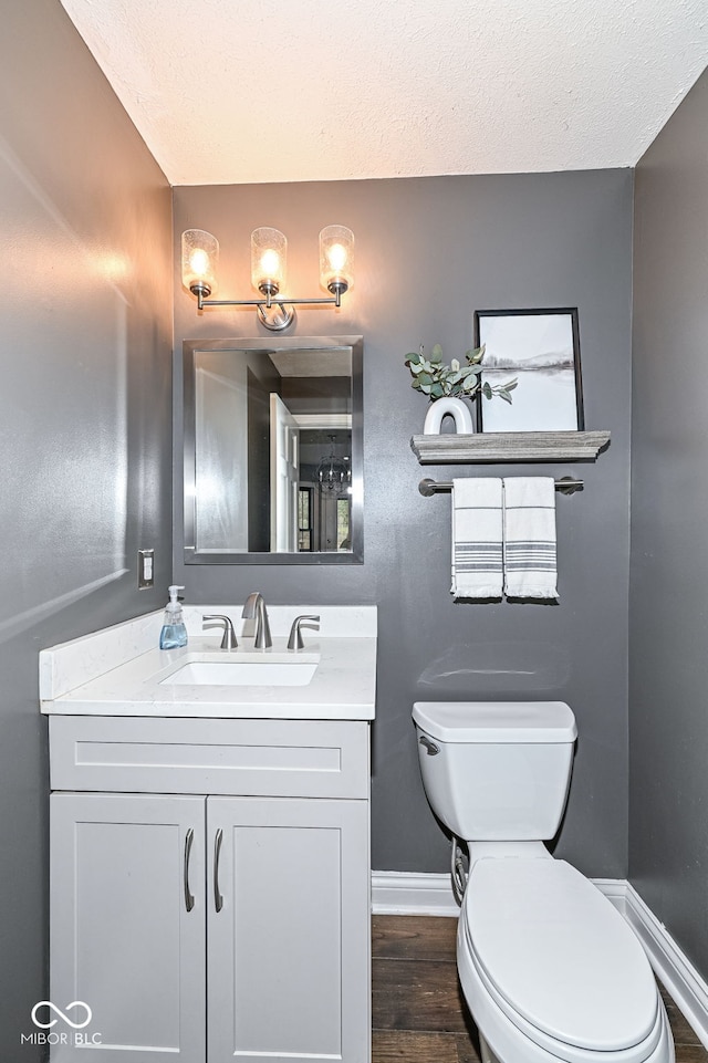 5826 Winding Way Ln, Indianapolis, IN 46220 - half bath with vanity, wood finished floors, and a textured ceiling