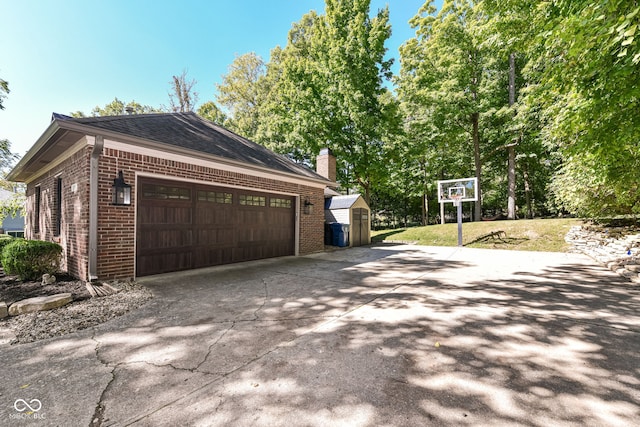 5826 Winding Way Ln, Indianapolis, IN 46220 - garage featuring concrete driveway and a shed