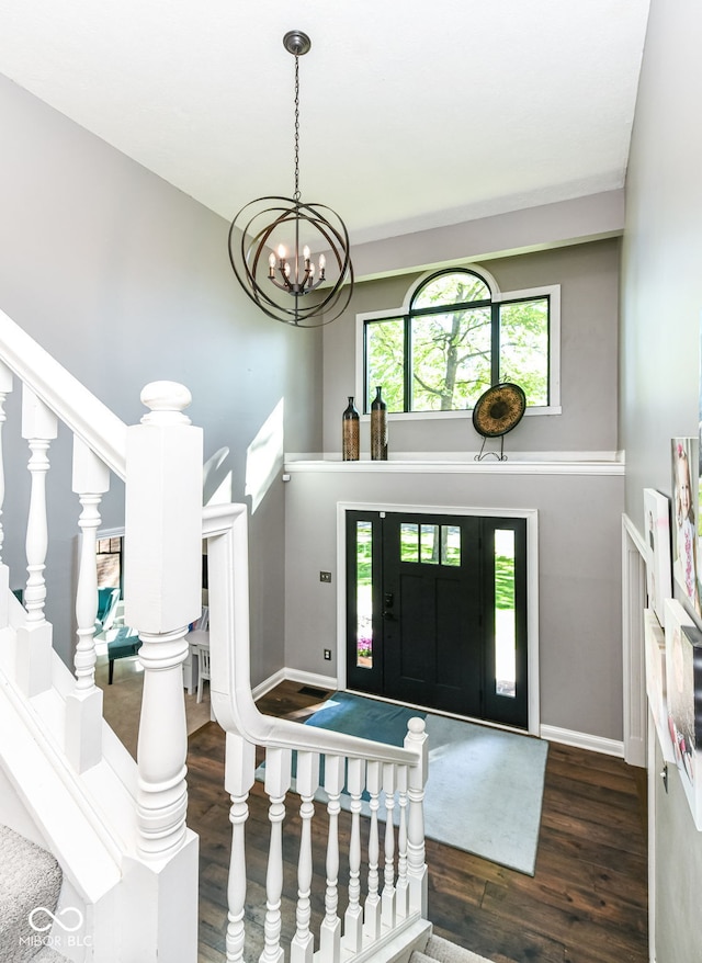 5826 Winding Way Ln, Indianapolis, IN 46220 - entryway featuring wood finished floors, a chandelier, and stairs
