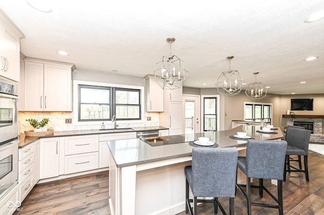 5826 Winding Way Ln, Indianapolis, IN 46220 - kitchen with a chandelier, stainless steel appliances, recessed lighting, dark wood-style flooring, and a center island
