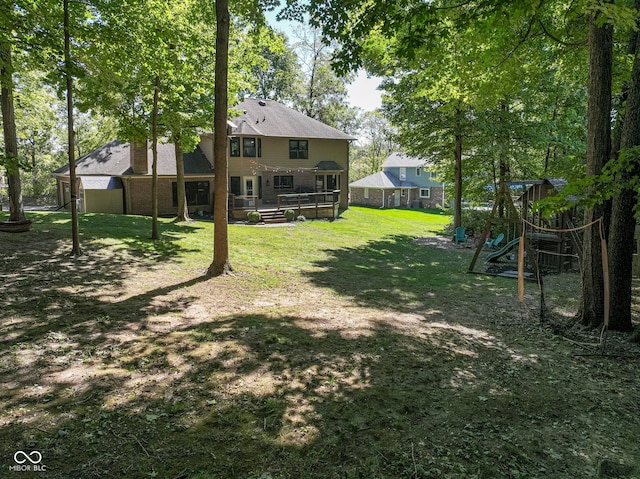 5826 Winding Way Ln, Indianapolis, IN 46220 - view of grassy yard featuring a playground and a wooden deck
