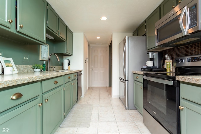 7612 Farm View Cir E, Indianapolis, IN 46256 - kitchen with appliances with stainless steel finishes, green cabinetry, light countertops, and recessed lighting