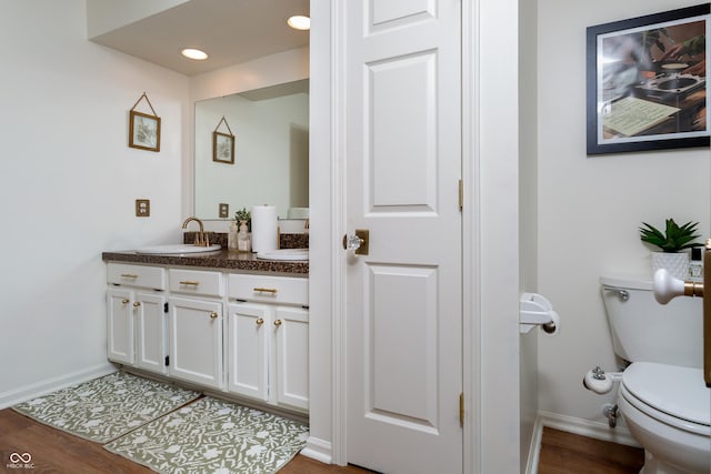 7612 Farm View Cir E, Indianapolis, IN 46256 - bathroom featuring vanity, wood finished floors, and recessed lighting