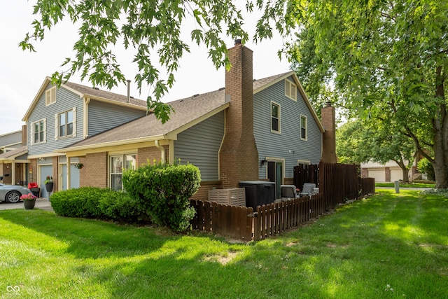 7612 Farm View Cir E, Indianapolis, IN 46256 - view of side of home featuring roof with shingles, a garage, brick siding, and a chimney