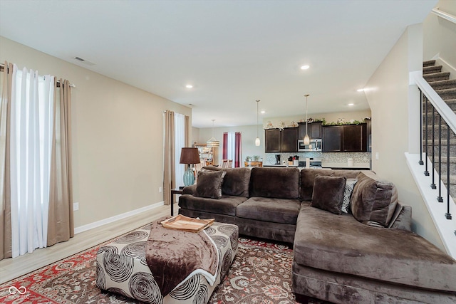 9806 Olympic Blvd, Pendleton, IN 46064 - living area featuring stairway, light wood-style flooring, and recessed lighting