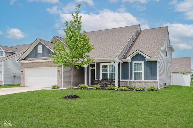 9806 Olympic Blvd, Pendleton, IN 46064 - view of front facade featuring brick siding, board and batten siding, an attached garage, concrete driveway, and covered porch