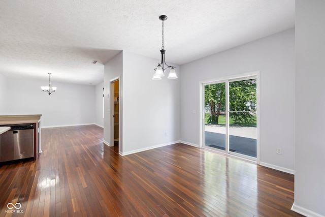 12997 Bartlett Dr, Fishers, IN 46037 - empty room featuring a chandelier, dark wood-type flooring, and a textured ceiling