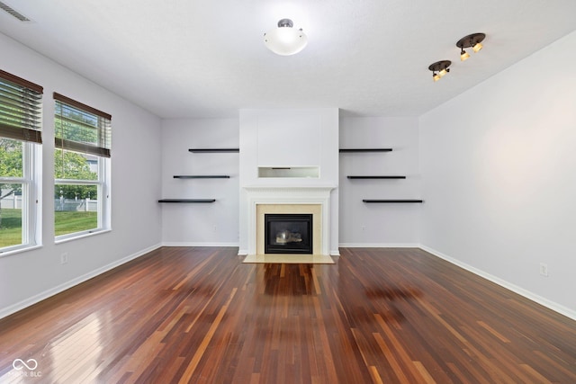 12997 Bartlett Dr, Fishers, IN 46037 - unfurnished living room featuring a fireplace with flush hearth and dark wood-type flooring