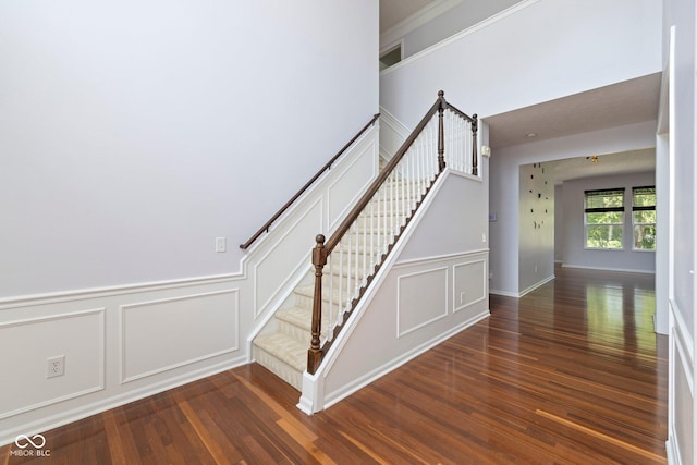 12997 Bartlett Dr, Fishers, IN 46037 - stairway featuring a decorative wall, wood finished floors, and wainscoting