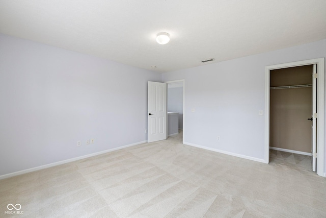 12997 Bartlett Dr, Fishers, IN 46037 - unfurnished bedroom featuring light carpet, a walk in closet, and a closet