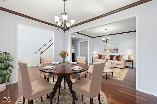 12997 Bartlett Dr, Fishers, IN 46037 - dining space featuring a chandelier, stairway, dark wood-type flooring, and crown molding