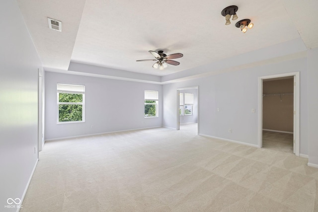 12997 Bartlett Dr, Fishers, IN 46037 - unfurnished room with a tray ceiling, light carpet, and ceiling fan