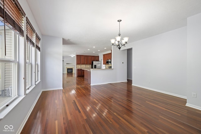 12997 Bartlett Dr, Fishers, IN 46037 - unfurnished living room with a chandelier, dark wood-type flooring, and recessed lighting