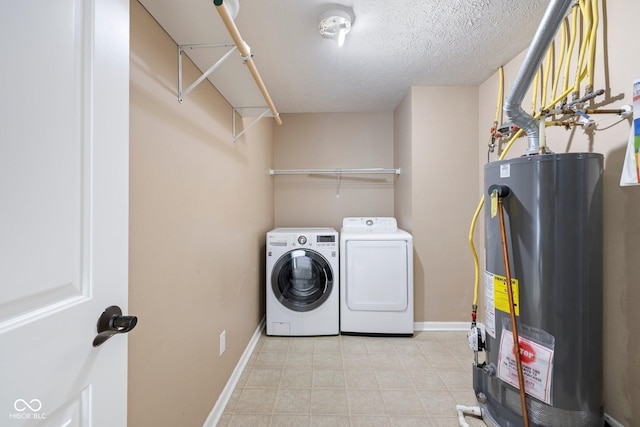12997 Bartlett Dr, Fishers, IN 46037 - washroom featuring gas water heater, washer and dryer, light tile patterned flooring, and a textured ceiling