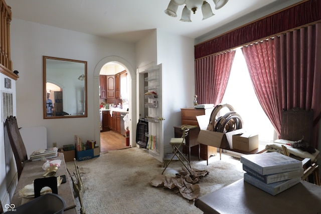 633 N E St, Greenfield, IN 46140 - living area with arched walkways, light carpet, and a chandelier