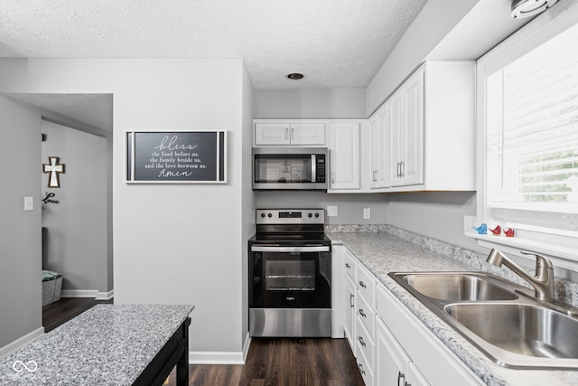 6429 Walnut Way, Brownsburg, IN 46112 - kitchen with appliances with stainless steel finishes, a textured ceiling, dark wood-style floors, light countertops, and white cabinetry