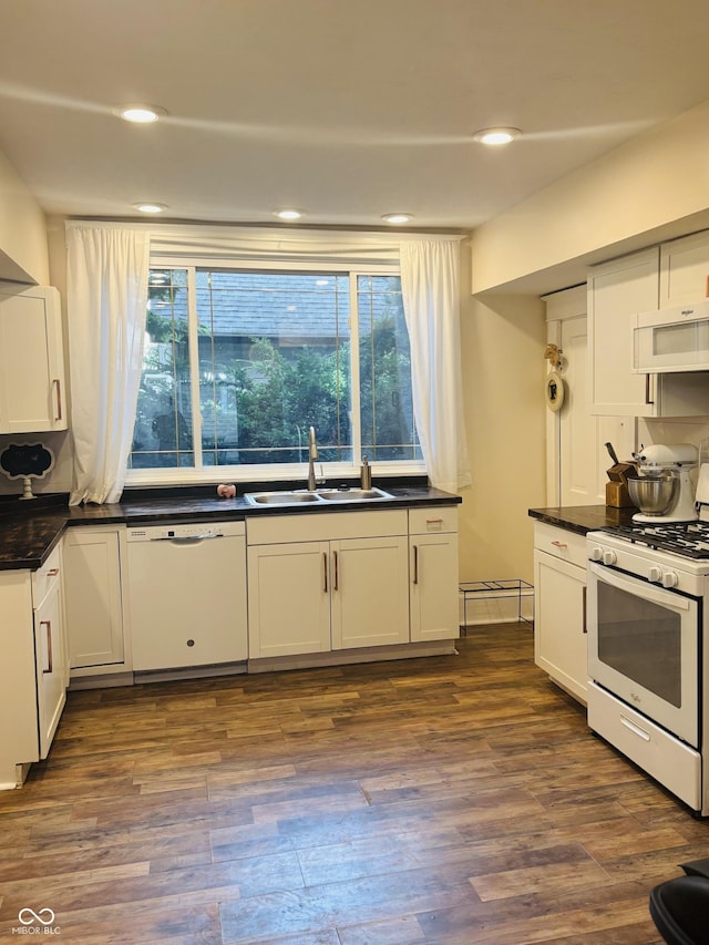 597 W Adams St, Franklin, IN 46131 - kitchen featuring white appliances, dark wood-type flooring, dark countertops, white cabinetry, and recessed lighting