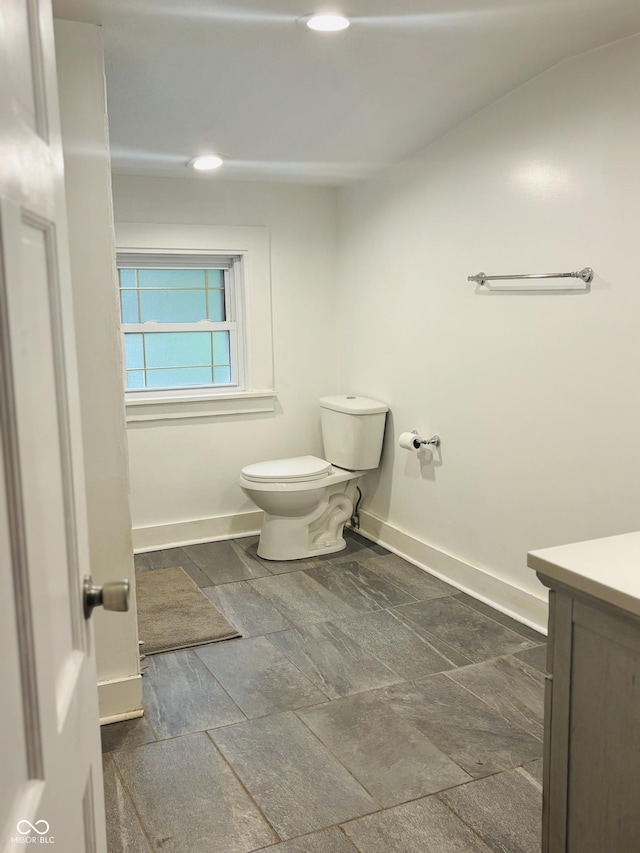 597 W Adams St, Franklin, IN 46131 - bathroom featuring vanity, recessed lighting, and stone tile floors