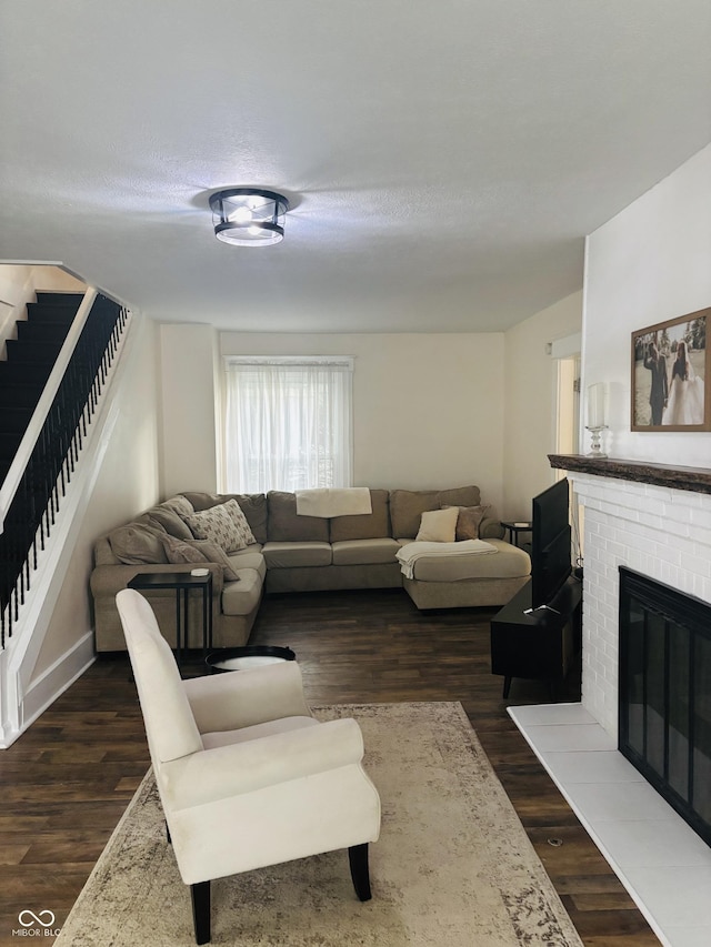 597 W Adams St, Franklin, IN 46131 - living room with stairway, dark wood-style flooring, and a fireplace