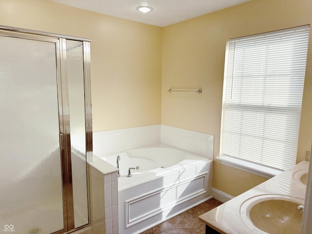 2444 Cole Branch Ct, Indianapolis, IN 46239 - bathroom featuring a stall shower, a jetted tub, double vanity, and plenty of natural light