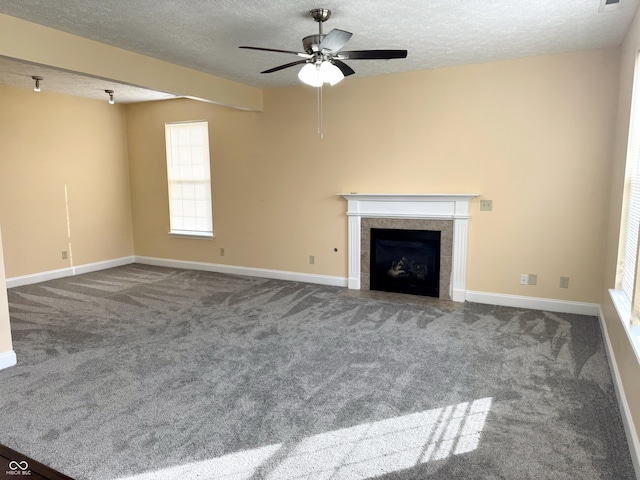 2444 Cole Branch Ct, Indianapolis, IN 46239 - unfurnished living room with a textured ceiling, a ceiling fan, a tiled fireplace, and carpet flooring