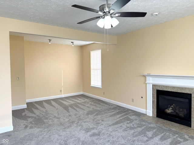 2444 Cole Branch Ct, Indianapolis, IN 46239 - unfurnished living room featuring a textured ceiling, carpet, ceiling fan, and a tiled fireplace