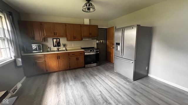 336 Brookside Ln, Plainfield, IN 46168 - kitchen featuring stainless steel appliances, under cabinet range hood, healthy amount of natural light, and light countertops