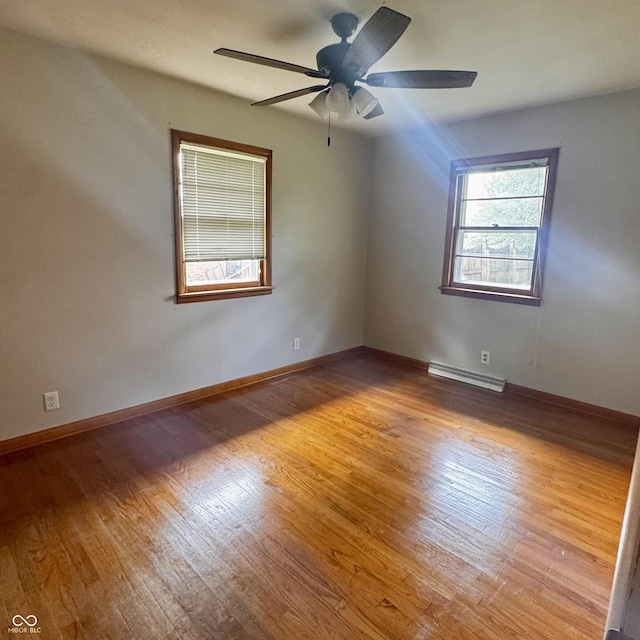 336 Brookside Ln, Plainfield, IN 46168 - unfurnished room with a baseboard radiator, wood finished floors, and a ceiling fan