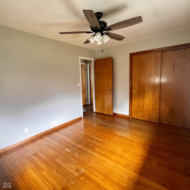 336 Brookside Ln, Plainfield, IN 46168 - unfurnished bedroom featuring light wood finished floors, a closet, and a ceiling fan