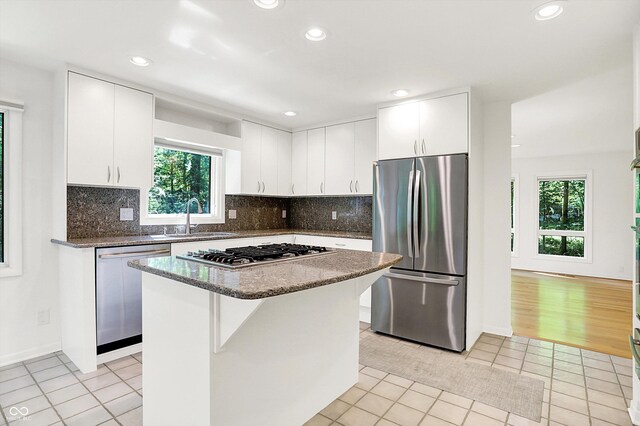 944 Briar Patch Ln, Greenwood, IN 46142 - kitchen featuring appliances with stainless steel finishes, healthy amount of natural light, recessed lighting, light tile patterned floors, and a kitchen island