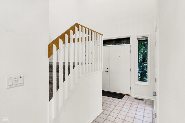 944 Briar Patch Ln, Greenwood, IN 46142 - foyer with light tile patterned floors, stairway, and a high ceiling