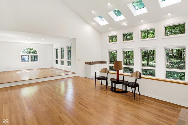 944 Briar Patch Ln, Greenwood, IN 46142 - sitting room featuring a skylight, high vaulted ceiling, light wood finished floors, and recessed lighting