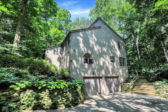 944 Briar Patch Ln, Greenwood, IN 46142 - view of home's exterior featuring an attached garage, stairs, and concrete driveway
