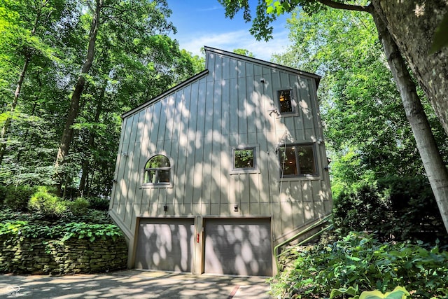 944 Briar Patch Ln, Greenwood, IN 46142 - view of side of property featuring an attached garage, concrete driveway, and board and batten siding