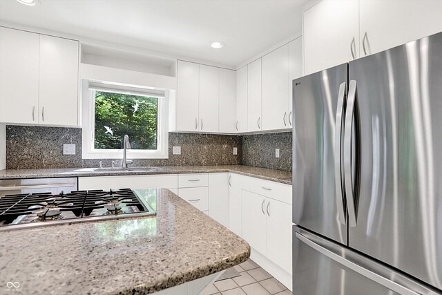 944 Briar Patch Ln, Greenwood, IN 46142 - kitchen featuring stainless steel appliances, light tile patterned flooring, light stone countertops, white cabinets, and recessed lighting