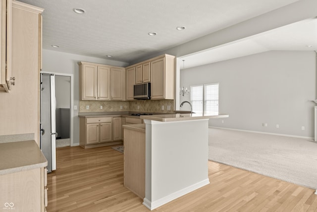 13172 Duval Dr, Fishers, IN 46037 - kitchen with light brown cabinetry, light wood-type flooring, a peninsula, tasteful backsplash, and recessed lighting