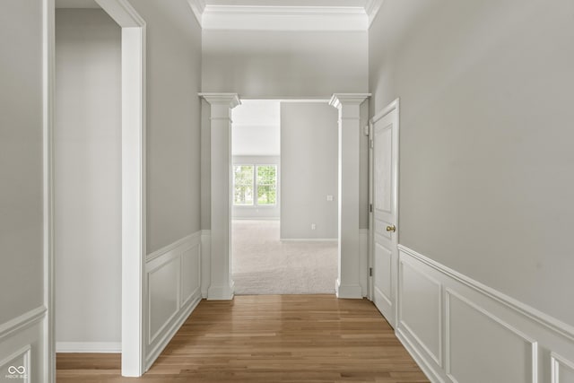 13172 Duval Dr, Fishers, IN 46037 - hall with light wood-style flooring, ornamental molding, a decorative wall, decorative columns, and wainscoting