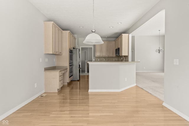 13172 Duval Dr, Fishers, IN 46037 - kitchen with light brown cabinets, open floor plan, stainless steel appliances, tasteful backsplash, and recessed lighting