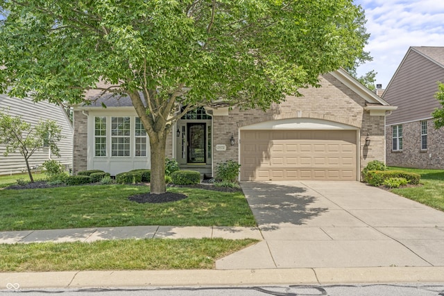 13172 Duval Dr, Fishers, IN 46037 - view of property hidden behind natural elements featuring a garage, driveway, and brick siding