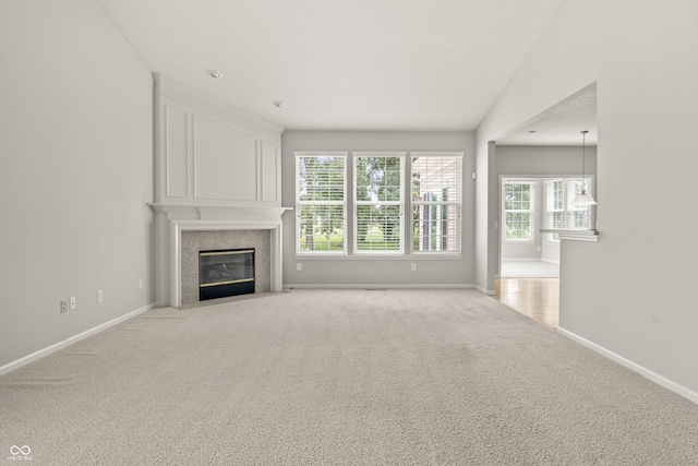 13172 Duval Dr, Fishers, IN 46037 - unfurnished living room featuring plenty of natural light, a tiled fireplace, and carpet floors