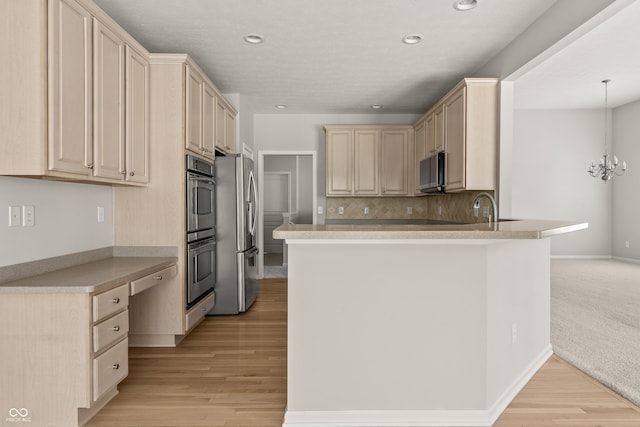 13172 Duval Dr, Fishers, IN 46037 - kitchen featuring appliances with stainless steel finishes, a peninsula, light brown cabinets, backsplash, and recessed lighting