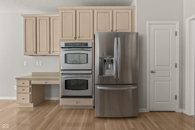 13172 Duval Dr, Fishers, IN 46037 - kitchen featuring appliances with stainless steel finishes, light wood-style flooring, and cream cabinets