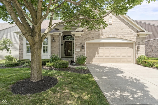 13172 Duval Dr, Fishers, IN 46037 - view of front of property with brick siding, driveway, a garage, roof with shingles, and a front lawn
