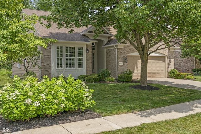 13172 Duval Dr, Fishers, IN 46037 - view of front of property with concrete driveway, a garage, brick siding, a front yard, and a shingled roof