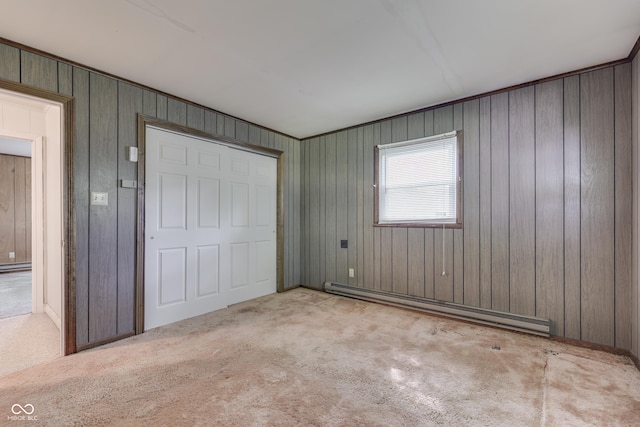 6637 E County Road 600 S, Plainfield, IN 46168 - unfurnished bedroom featuring a baseboard heating unit, carpet floors, wooden walls, and a closet