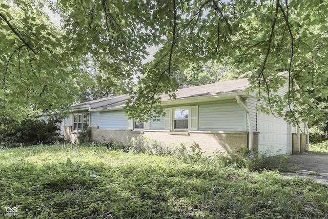 6637 E County Road 600 S, Plainfield, IN 46168 - ranch-style home with brick siding, an attached garage, and driveway