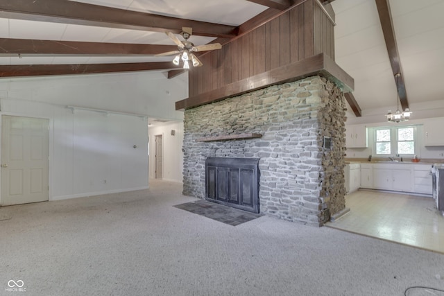6637 E County Road 600 S, Plainfield, IN 46168 - unfurnished living room with beamed ceiling, a ceiling fan, light colored carpet, a stone fireplace, and high vaulted ceiling