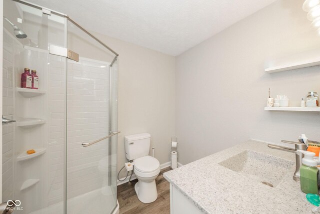 901 N Greenbriar Rd, Muncie, IN 47304 - full bathroom with vanity, wood finished floors, a shower stall, and a textured ceiling