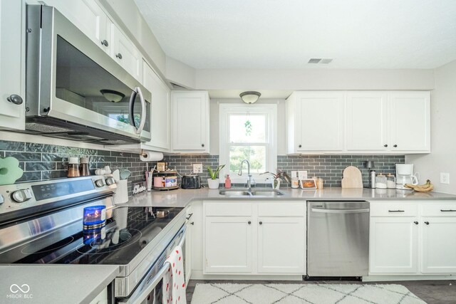 901 N Greenbriar Rd, Muncie, IN 47304 - kitchen featuring appliances with stainless steel finishes, tasteful backsplash, and white cabinetry