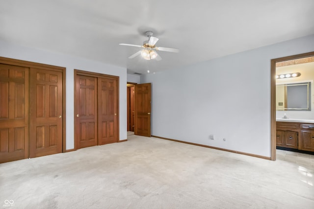 8439 Goldfinch Cir, Indianapolis, IN 46256 - unfurnished bedroom with multiple closets, light colored carpet, ensuite bath, and ceiling fan